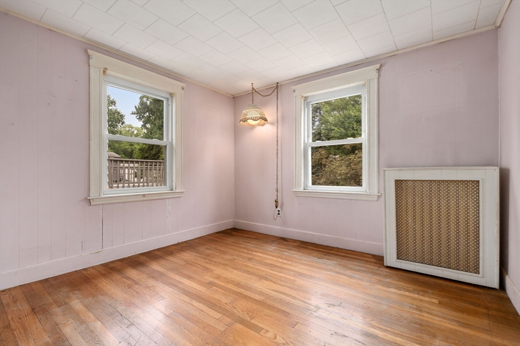 15 Atlantis Street Boston, MA 02132 - Photo 10 of 25 a view of an empty room with wooden floor and a window