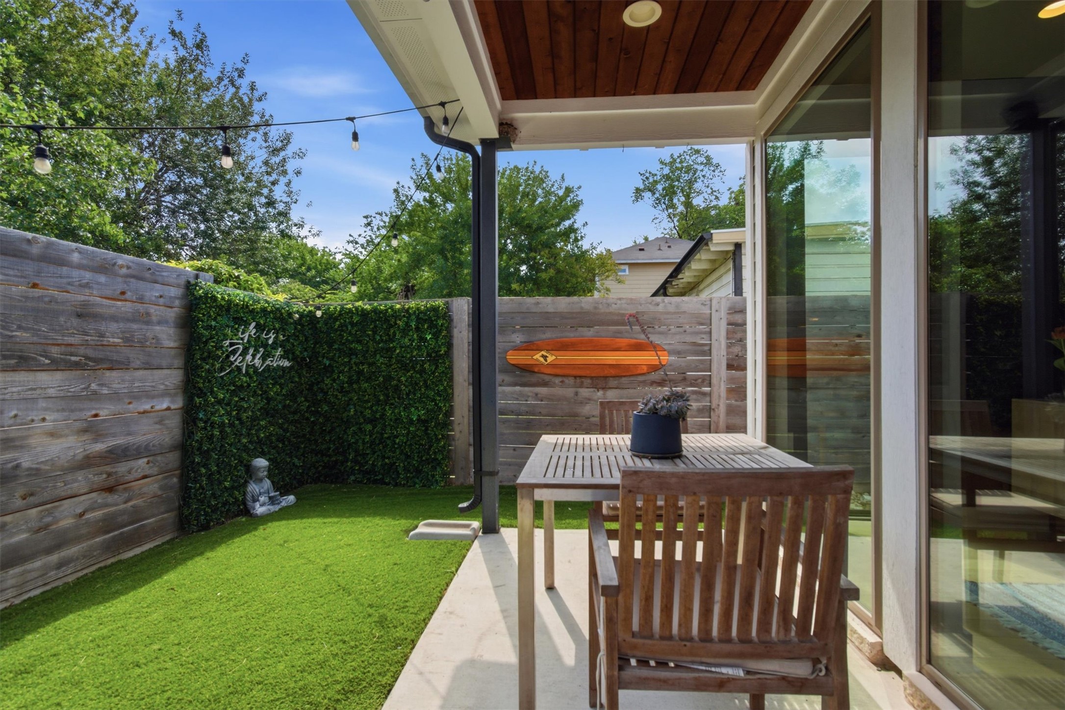 2710 Zaragosa Street, Unit A Austin, TX 78702 - Photo 28 of 29 Private fenced backyard with a covered patio and turf lawn — low-maintenance outdoor living off the main floor.