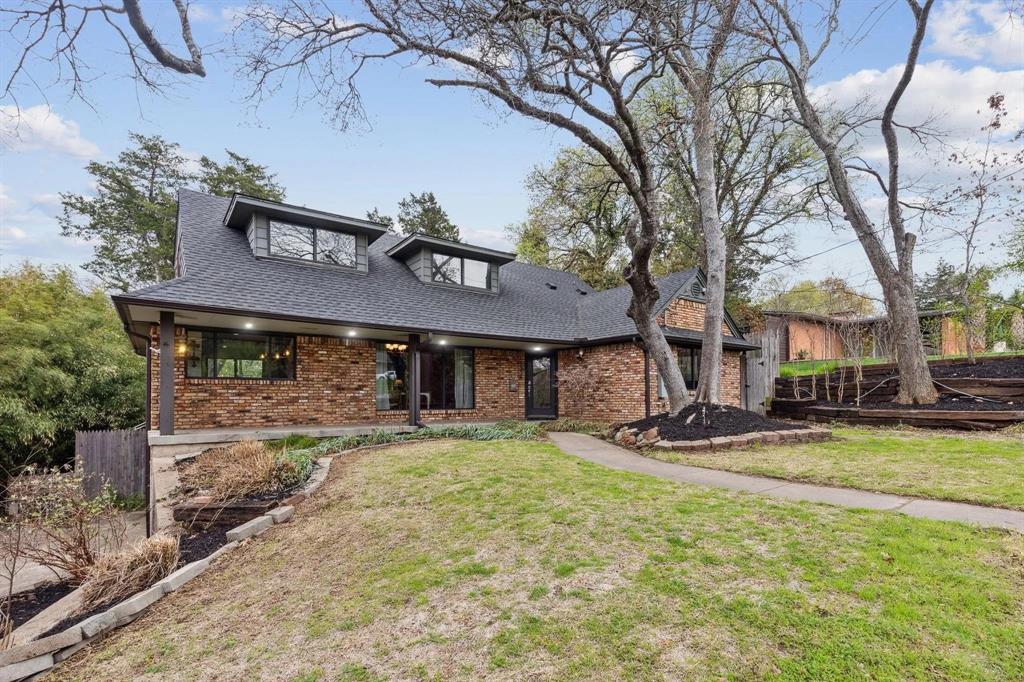 a view of a house with a yard patio and fire pit