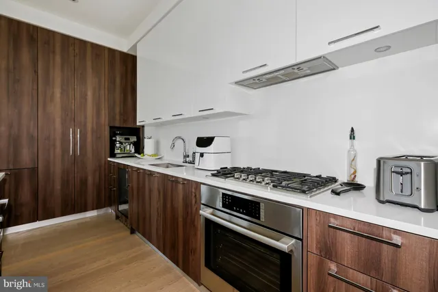 a kitchen with stainless steel appliances a stove and a refrigerator