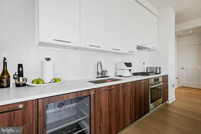 a kitchen with sink a stove and cabinets