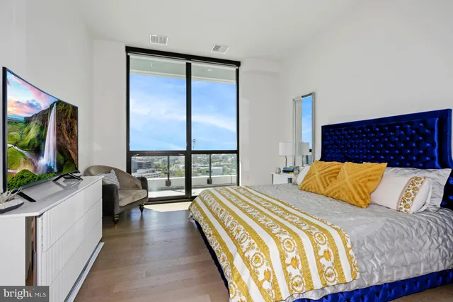 a bedroom with a bed and a flat screen tv