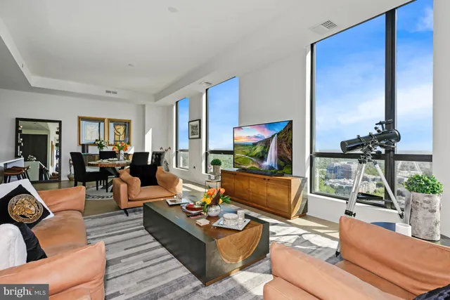 a living room with furniture fireplace and a table