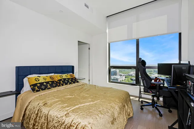 a bedroom with a bed and a chair in it