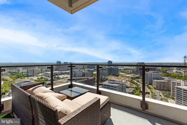 a view of a terrace with couches and sky view