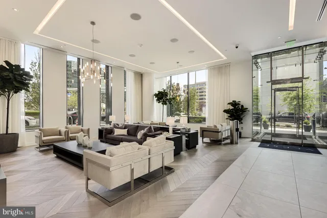 a living room with furniture and large windows