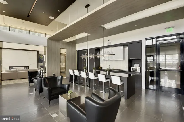 a dining hall with couches a dining table and chairs with wooden floor