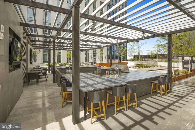 a view of a dining room with furniture large windows and wooden floor