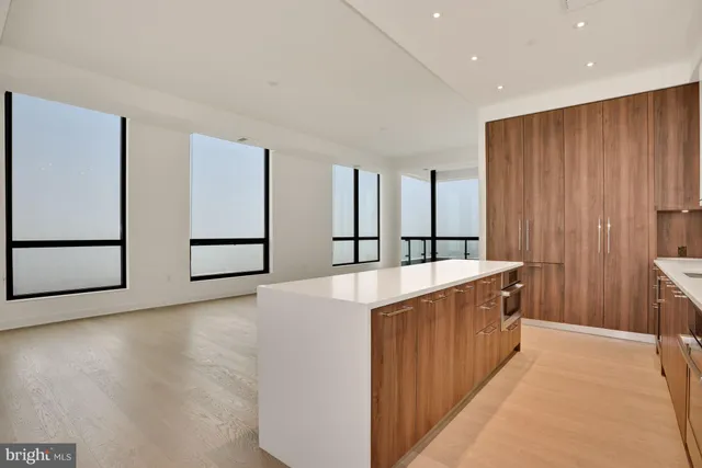 a view of a kitchen with cabinets and wooden floor