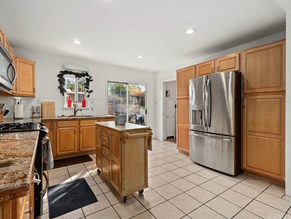 7356 Leescott Avenue Van Nuys, CA 91406 - Photo 11 of 31 a kitchen with stainless steel appliances granite countertop a refrigerator and a stove top oven