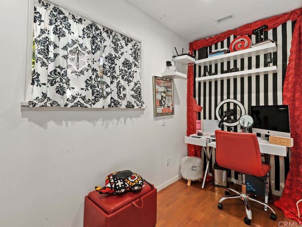 7356 Leescott Avenue Van Nuys, CA 91406 - Photo 13 of 31 a bedroom with a bed and a bookshelf in it