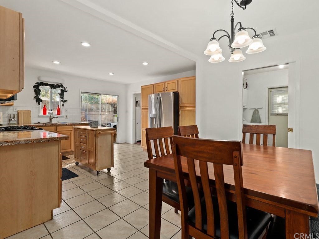 7356 Leescott Avenue Van Nuys, CA 91406 - Photo 17 of 31 a view of a dining room with furniture and a chandelier