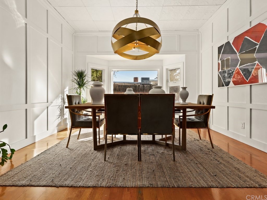 7356 Leescott Avenue Van Nuys, CA 91406 - Photo 19 of 31 a view of a dining room with furniture and wooden floor