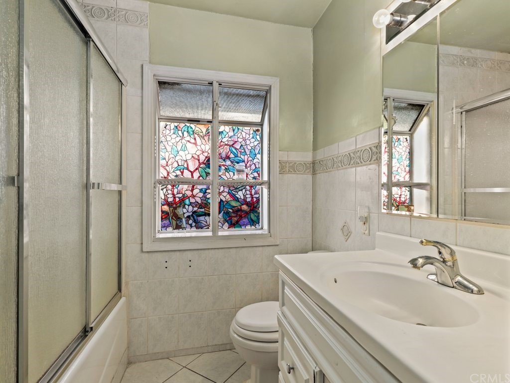 7356 Leescott Avenue Van Nuys, CA 91406 - Photo 20 of 31 a bathroom with a sink and mirror with toilet