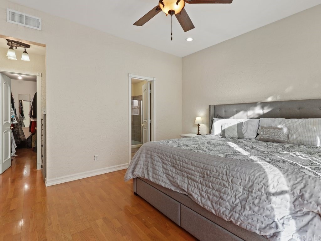 7356 Leescott Avenue Van Nuys, CA 91406 - Photo 25 of 31 a bedroom with a bed and painting on the wall