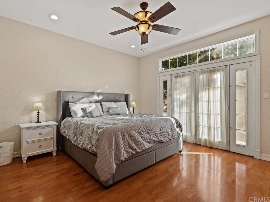 7356 Leescott Avenue Van Nuys, CA 91406 - Photo 26 of 31 a bedroom with a large bed and a chandelier fan