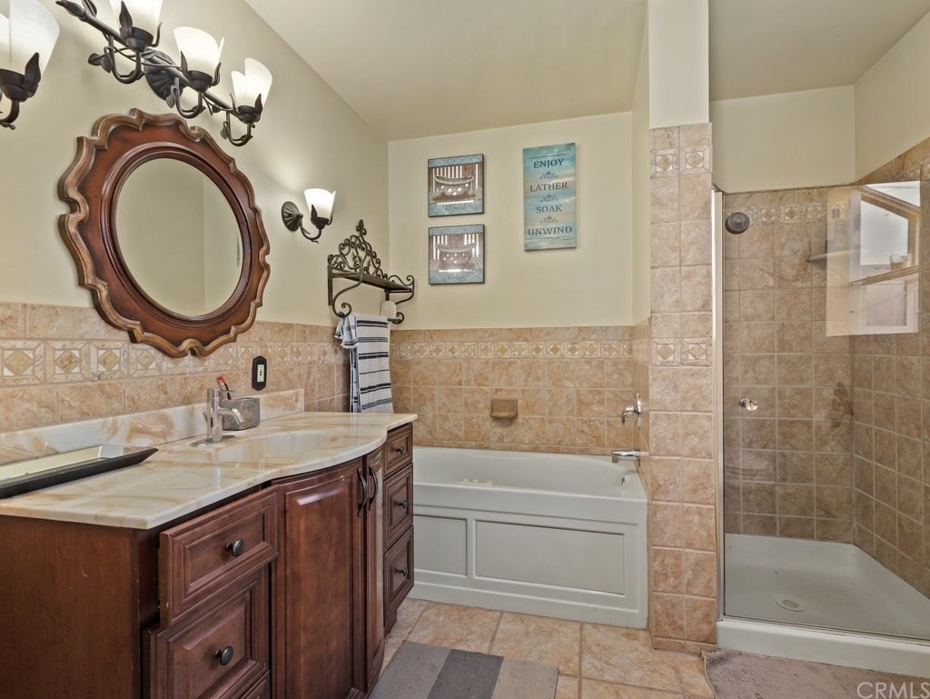 7356 Leescott Avenue Van Nuys, CA 91406 - Photo 3 of 31 a bathroom with a sink a toilet and a mirror