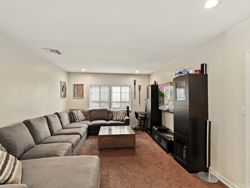 7356 Leescott Avenue Van Nuys, CA 91406 - Photo 8 of 31 a living room with furniture fireplace and a window