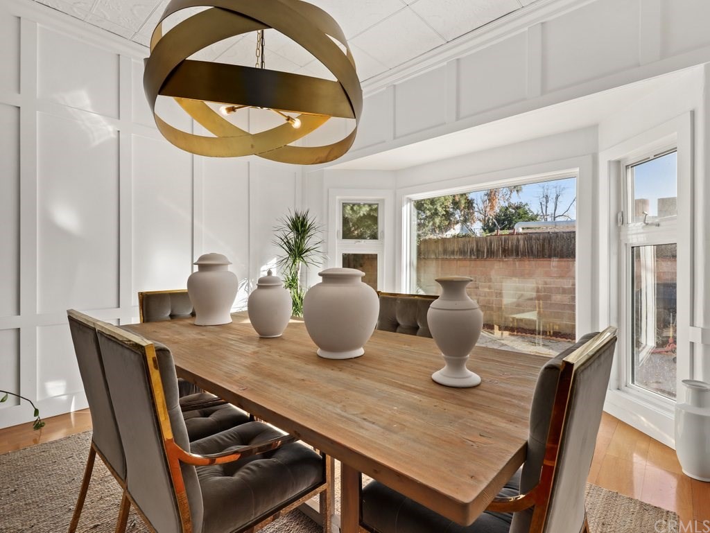 7356 Leescott Avenue Van Nuys, CA 91406 - Photo 9 of 31 a dining room with furniture and a mirror