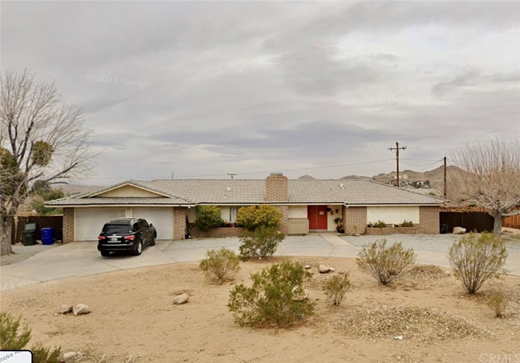 16184 Rimrock Road Apple Valley, CA 92307 - Photo 1 of 1 a car parked in front of a house