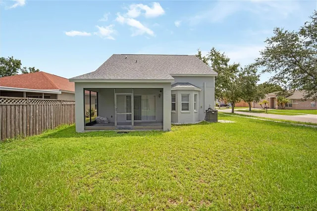 a view of a house with a yard and sitting area