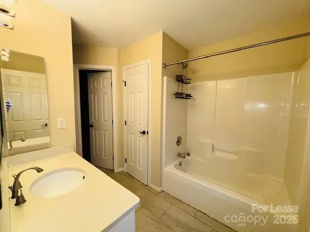 a bathroom with a tub a sink and shower