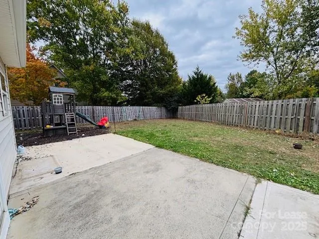 a view of a backyard with a small cabin and a chair