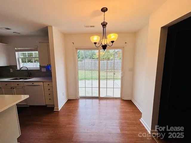 a view of a kitchen with a dishwasher cabinets and a wooden floor