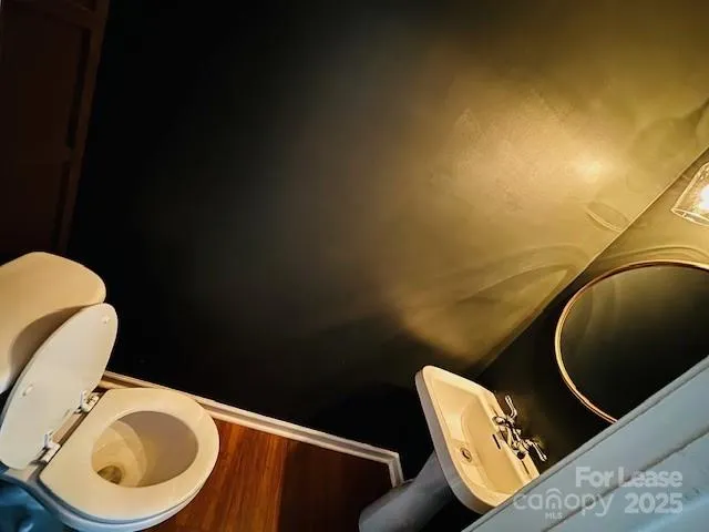 a blue painted room with a chair and wooden floor