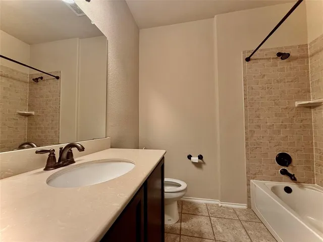 a bathroom with a sink a toilet a mirror a tub and shower