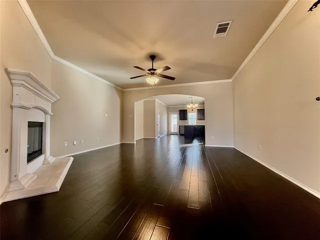 a view of a livingroom with wooden floor and a ceiling fan