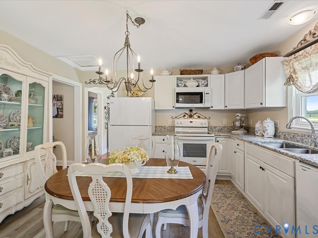 4 Memory Lane Cumberland, VA 23040 - Photo 12 of 37 a kitchen with stainless steel appliances granite countertop a dining table chairs and a refrigerator