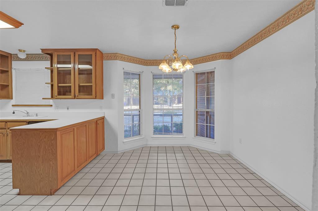 1108 Pine Ridge Drive Azle, TX 76020 - Photo 12 of 40 a very nice looking empty room with a fireplace and a chandelier