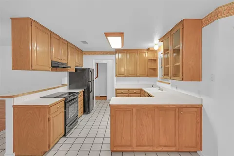 a kitchen with a stove a sink and a refrigerator