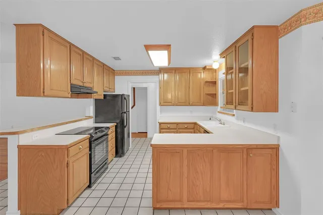 a kitchen with a stove a sink and a refrigerator