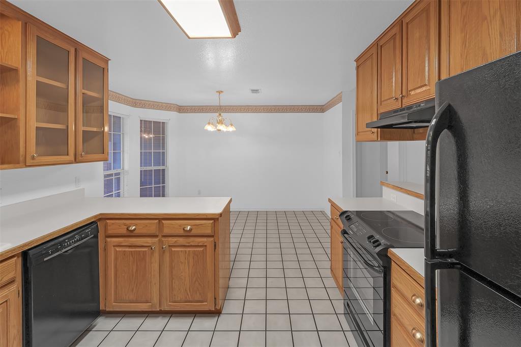 1108 Pine Ridge Drive Azle, TX 76020 - Photo 14 of 40 a kitchen with a refrigerator stove and cabinets