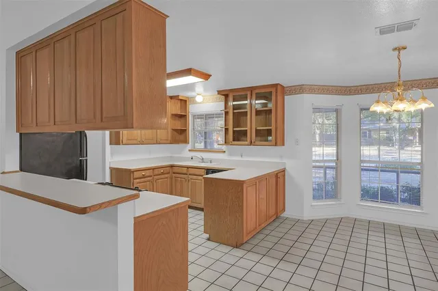 a kitchen with stainless steel appliances wooden cabinets a stove and a refrigerator