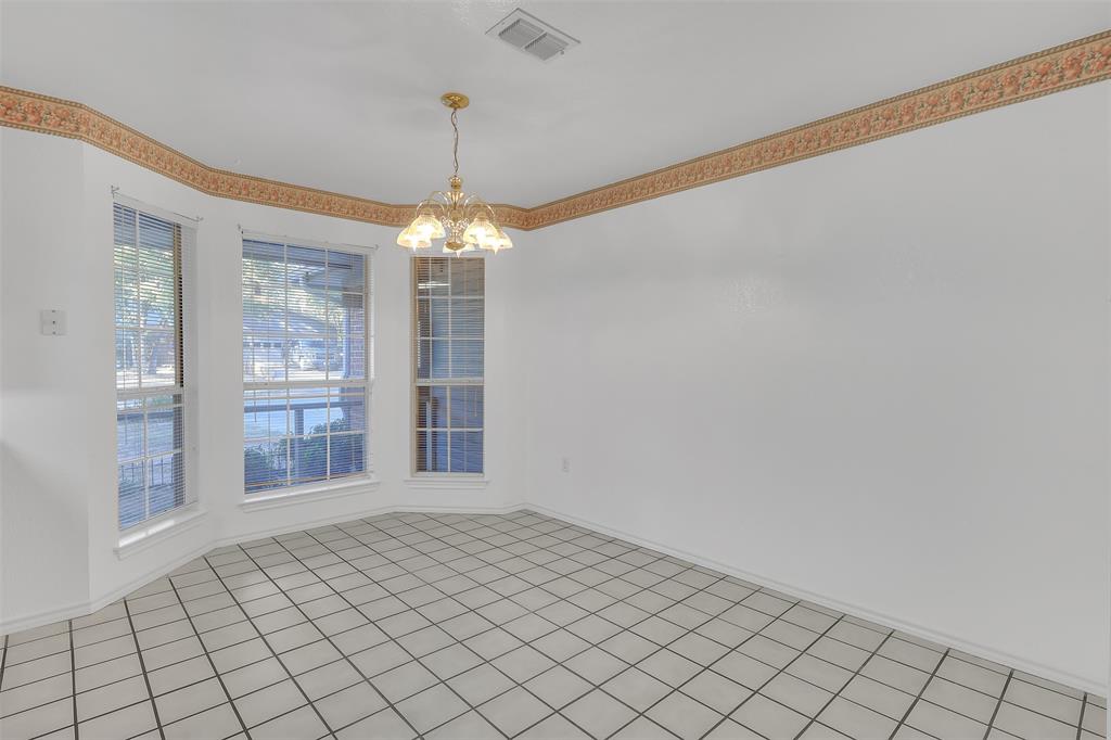 1108 Pine Ridge Drive Azle, TX 76020 - Photo 17 of 40 a view of an empty room with window and chandelier fan