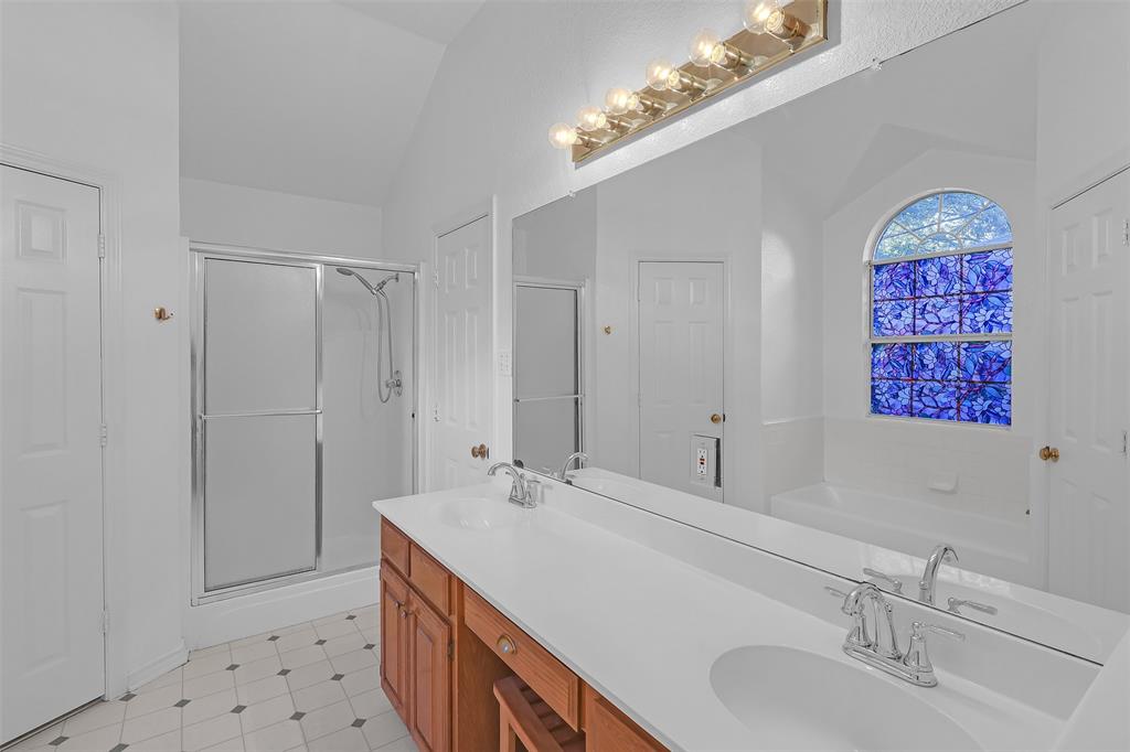 1108 Pine Ridge Drive Azle, TX 76020 - Photo 23 of 40 a bathroom with a sink a mirror and a shower
