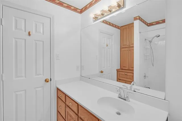 a bedroom with a bed and a potted plant