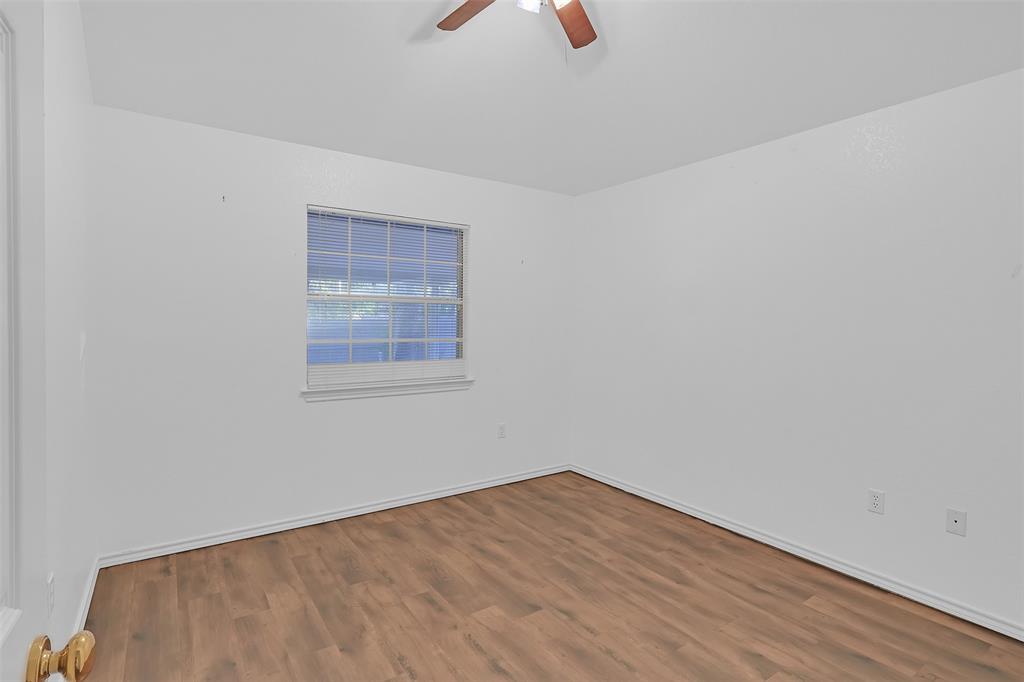 1108 Pine Ridge Drive Azle, TX 76020 - Photo 32 of 40 a view of an empty room with wooden floor