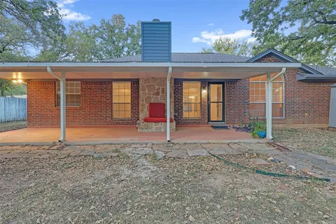 a swimming pool with yard and trees in the background