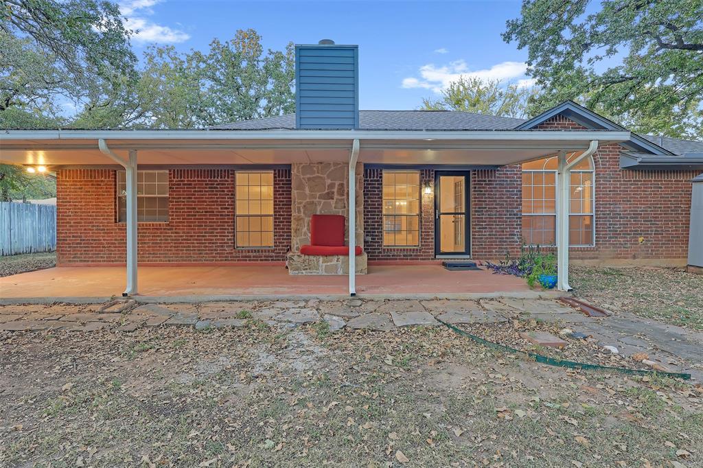 1108 Pine Ridge Drive Azle, TX 76020 - Photo 35 of 40 a view of a house with a backyard and large tree