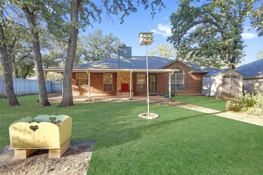 1108 Pine Ridge Drive Azle, TX 76020 - Photo 38 of 40 a front view of a house with a garden