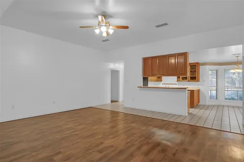 a view of kitchen with cabinets and window