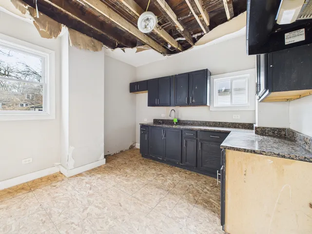 a kitchen with stainless steel appliances granite countertop a sink refrigerator and microwave