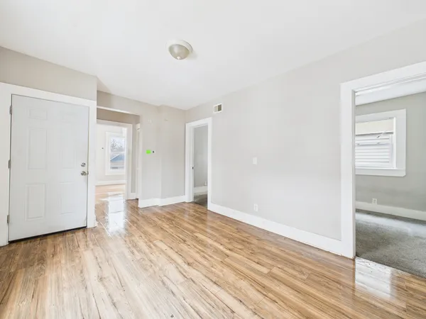 a view of an empty room and wooden floor