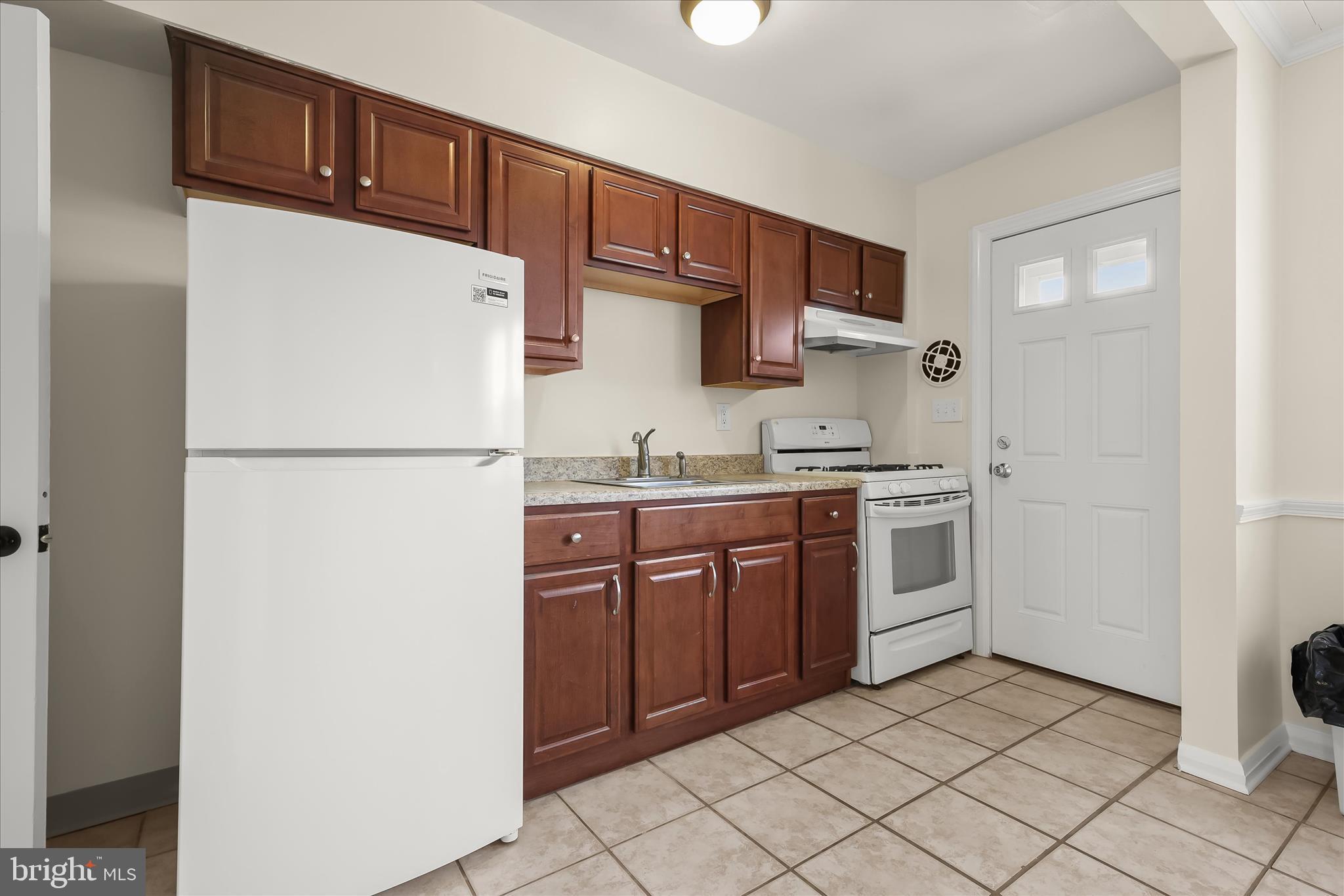 8307 Ridgely Oak Road Baltimore, MD 21234 - Photo 10 of 30 a kitchen with a refrigerator sink and stove