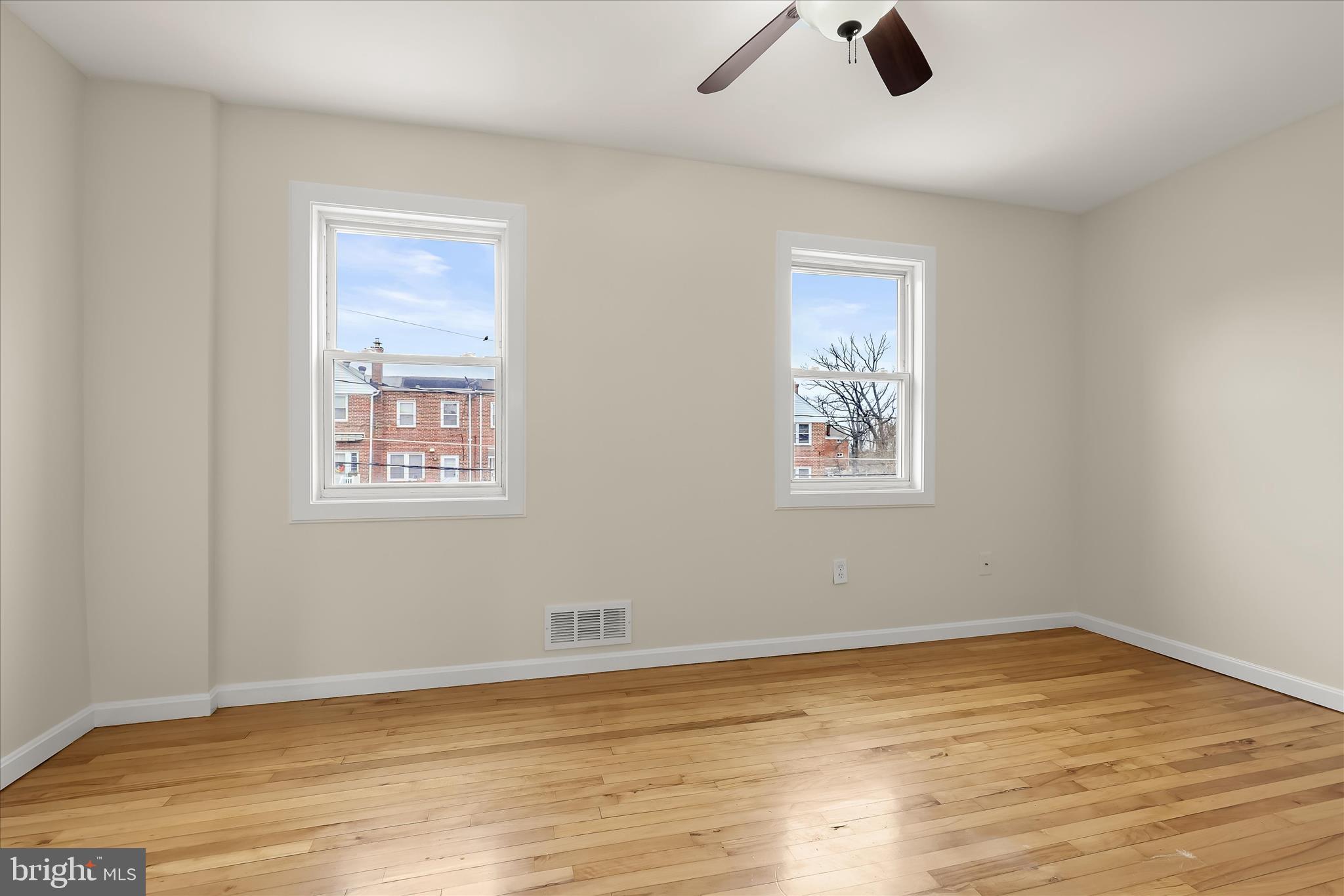 8307 Ridgely Oak Road Baltimore, MD 21234 - Photo 13 of 30 a view of empty room with wooden floor and window