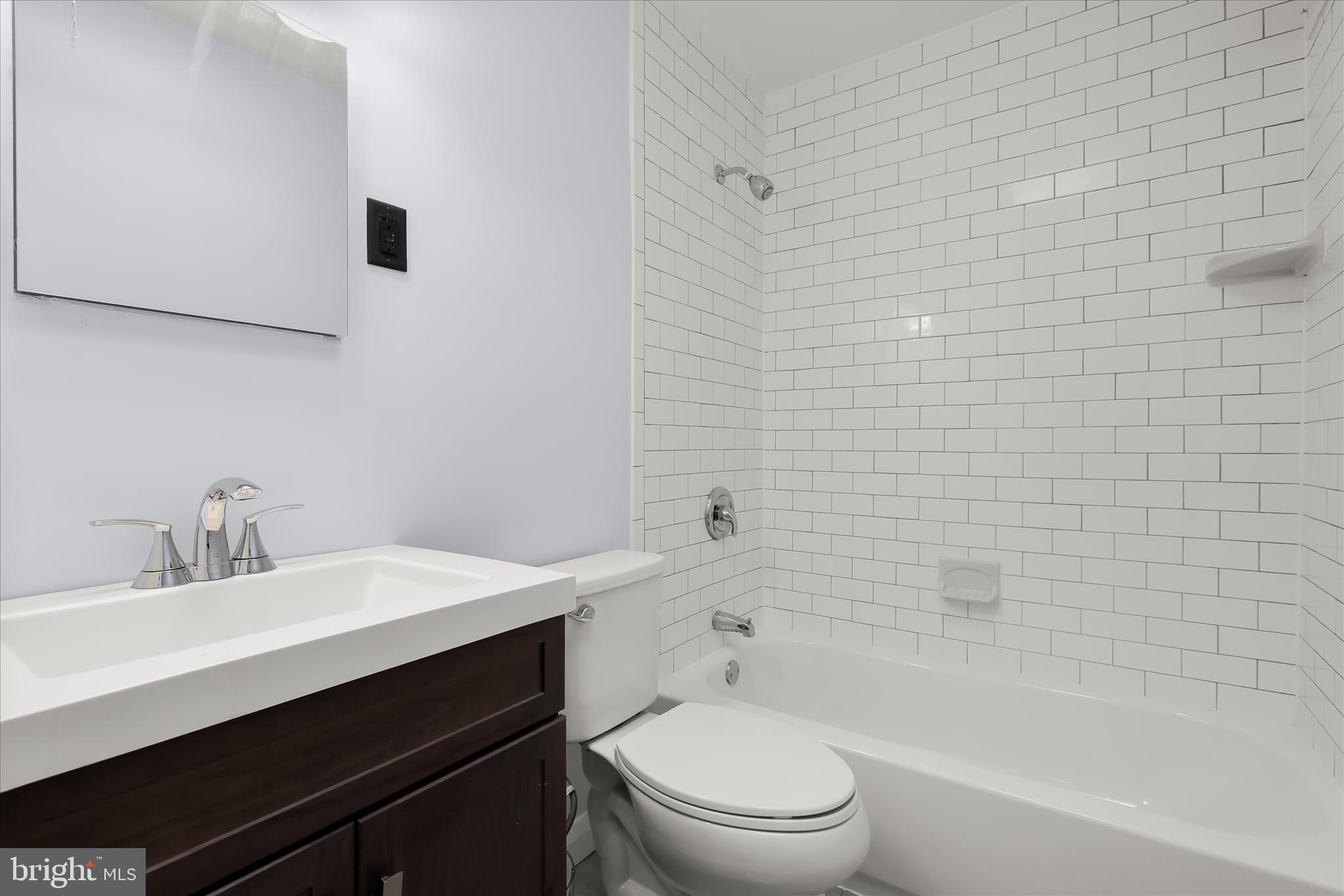 8307 Ridgely Oak Road Baltimore, MD 21234 - Photo 15 of 30 a bathroom with a sink a toilet and shower